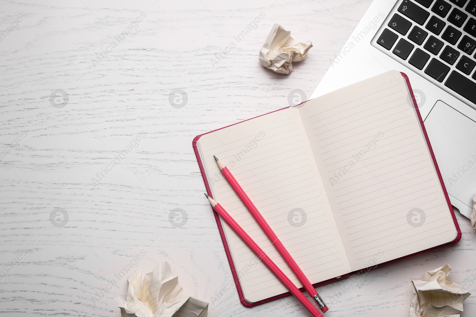 Photo of Flat lay composition with notebook and crumpled paper on white wooden table. Space for text