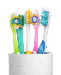 Photo of Different toothbrushes in holder isolated on white
