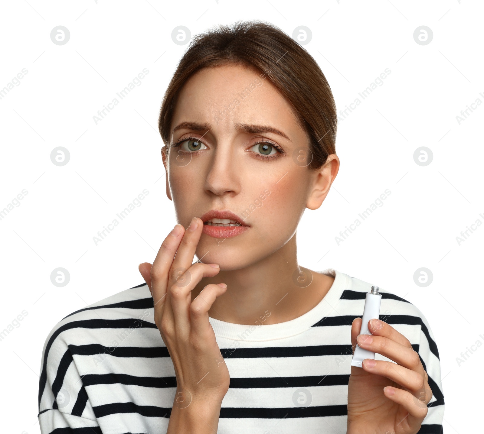 Photo of Woman with herpes applying cream onto lip against white background