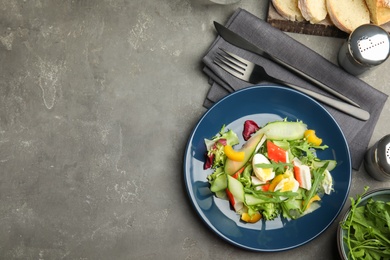 Photo of Delicious salad with crab sticks and lettuce on grey table, flat lay. Space for text