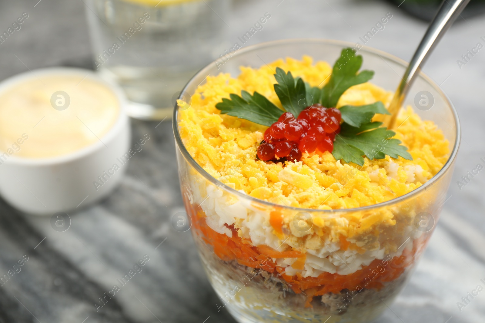 Photo of Traditional russian salad Mimosa served on table, closeup