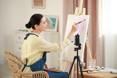 Photo of Teacher conducting online painting lesson at home. Time for hobby