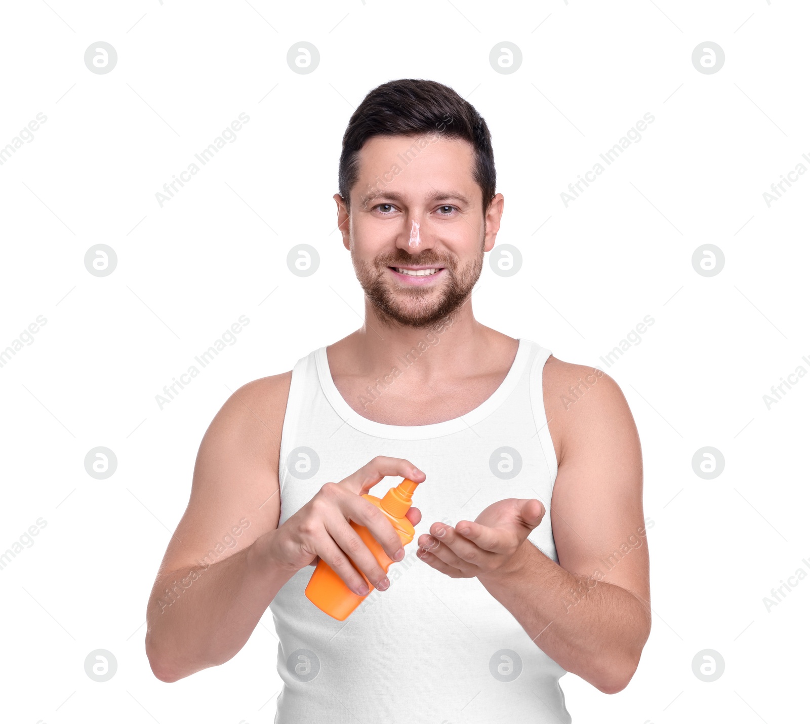 Photo of Handsome man with bottle of sun protection cream on white background