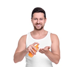 Photo of Handsome man with bottle of sun protection cream on white background