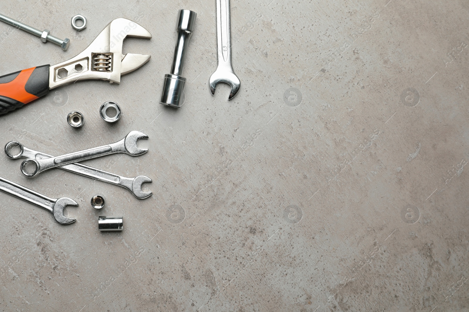 Photo of Auto mechanic's tools on grey background, flat lay. Space for text