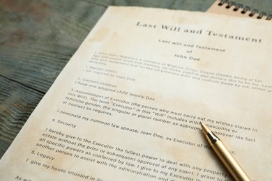 Photo of Last Will and Testament and pen on rustic wooden table, closeup