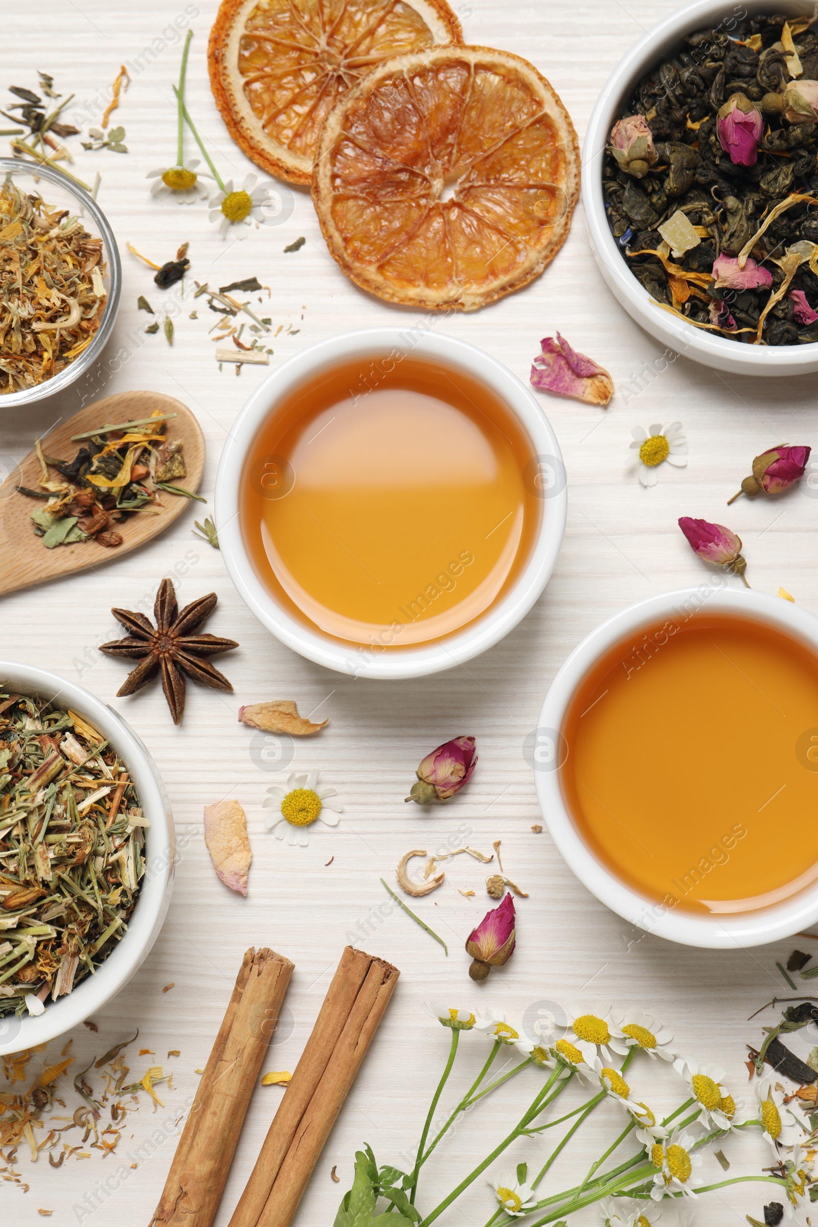 Photo of Flat lay composition with fresh brewed tea and dry leaves on white wooden table