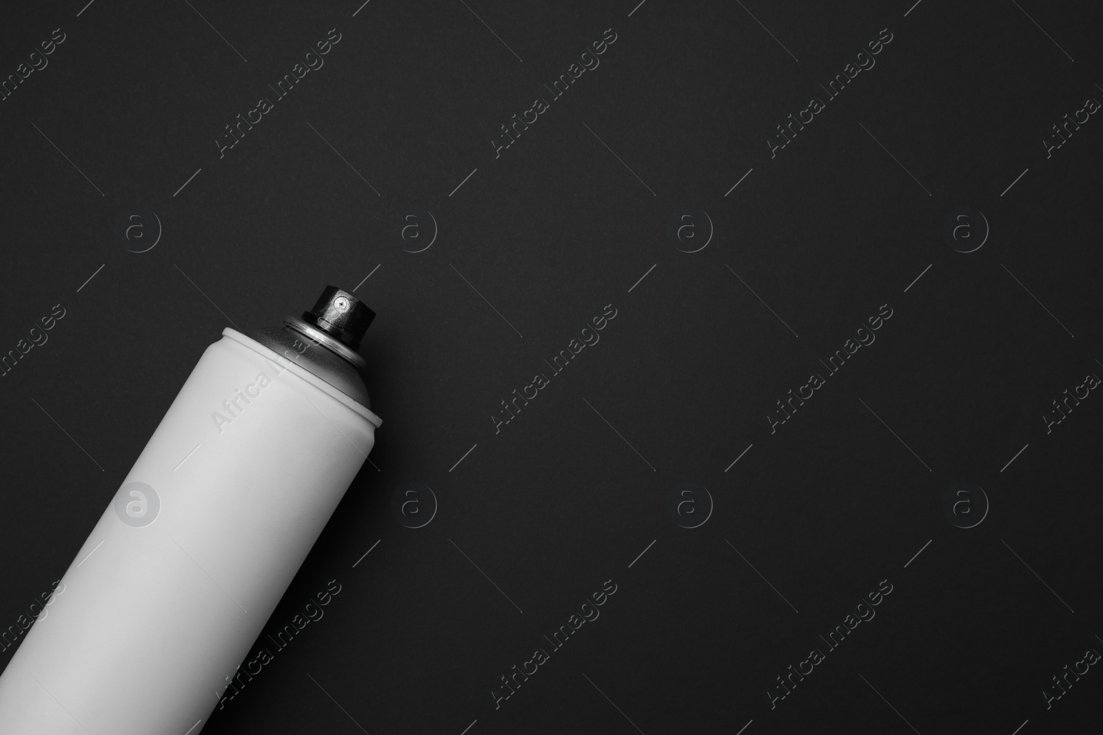 Photo of Can of graffiti spray paint on black background, top view. Space for text