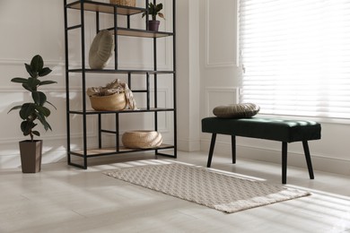 Stylish rug with pattern on floor in room