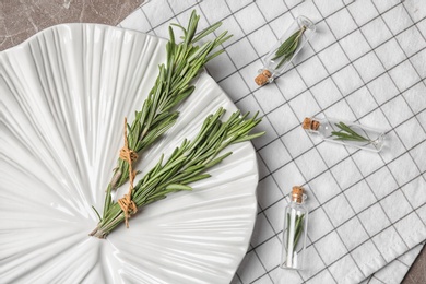 Flat lay composition with rosemary on table. Aromatic herbs