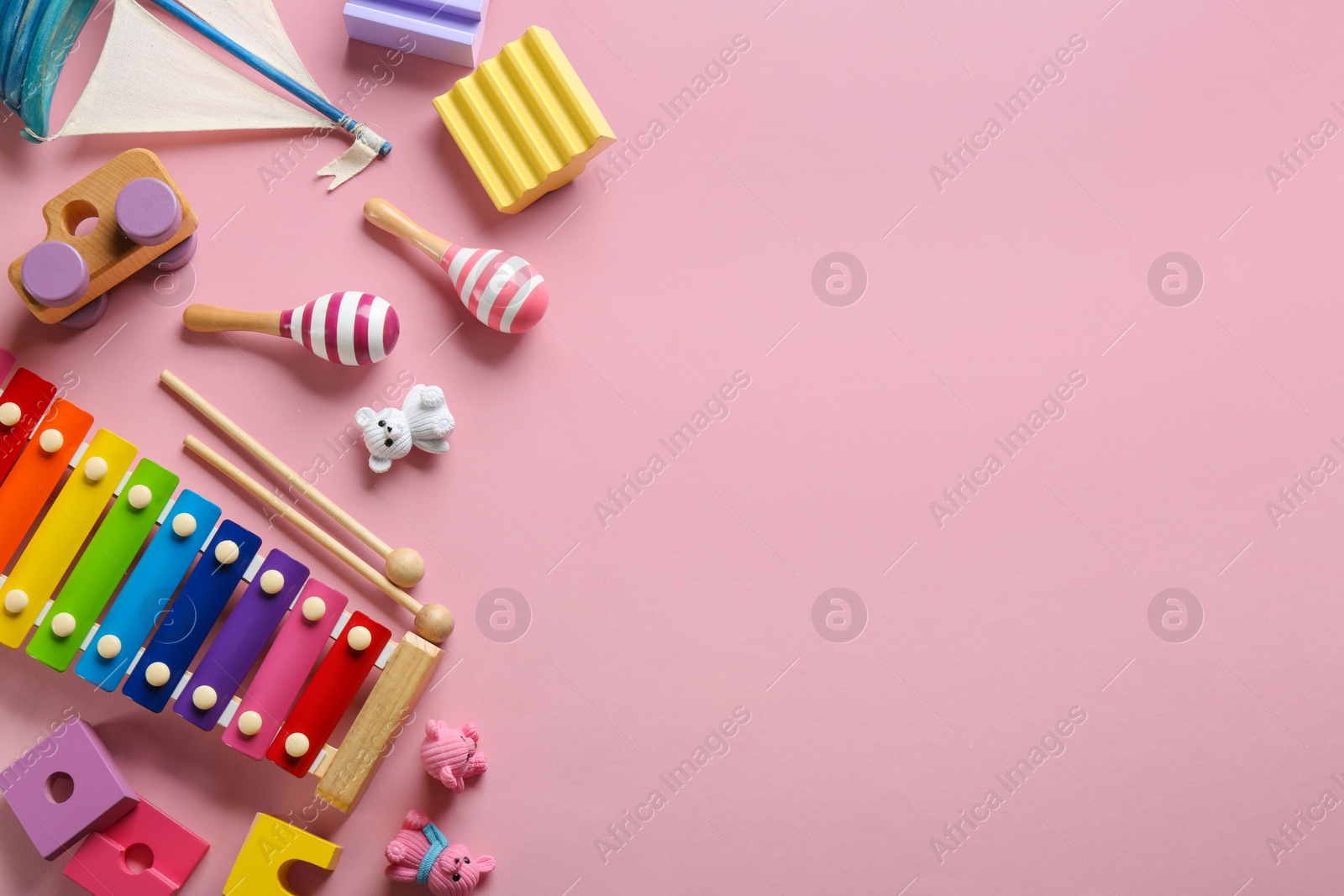 Photo of Flat lay composition with different toys on pink background. Space for text