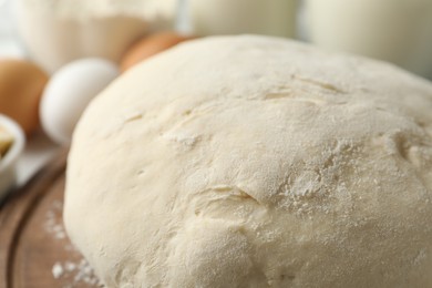 Raw dough for pastries on table, closeup