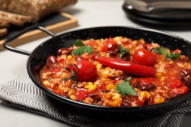 Dish with chili con carne on table