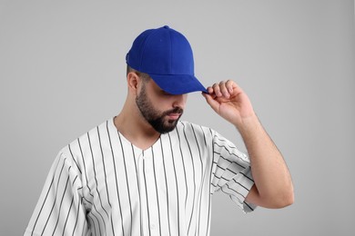 Photo of Man in stylish blue baseball cap on light grey background