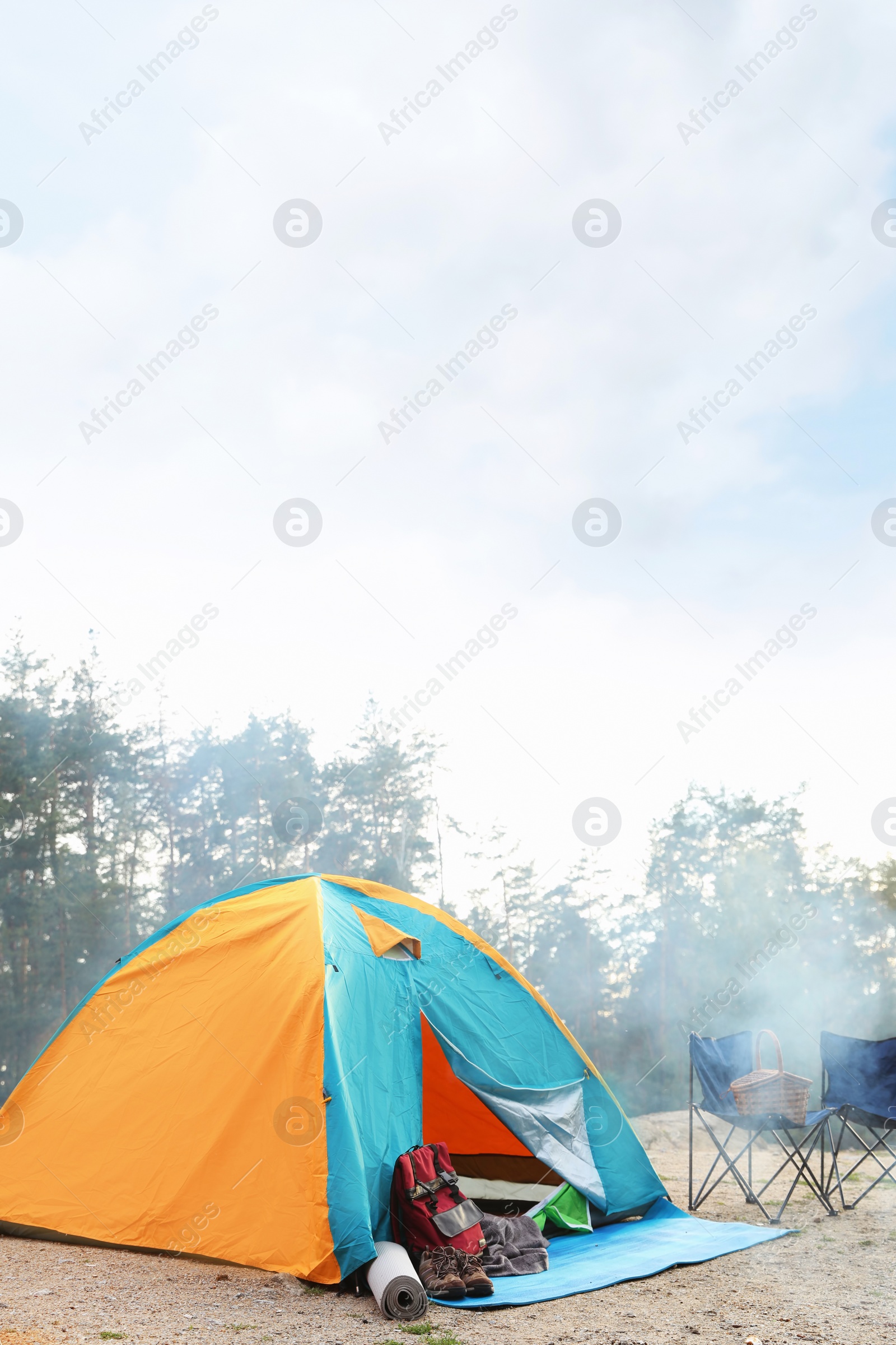 Photo of Camping tent and accessories in wilderness on summer day