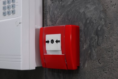 Photo of Fire alarm push button on grey wall