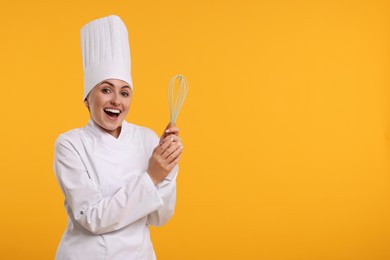 Photo of Happy professional confectioner in uniform holding whisk on yellow background. Space for text