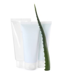 Photo of Tubes of hand cream and aloe on white background