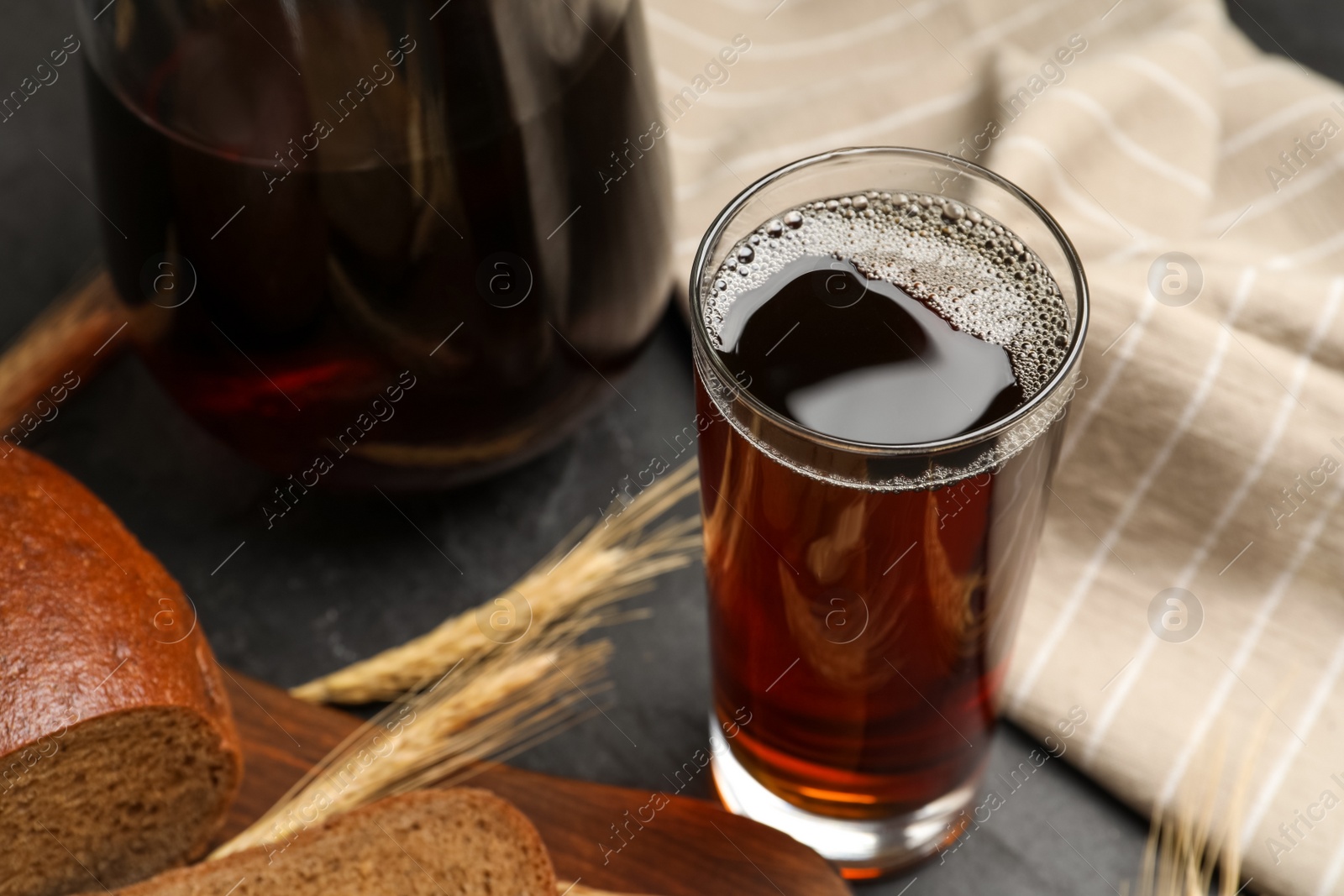 Photo of Glass of delicious kvass on table, closeup
