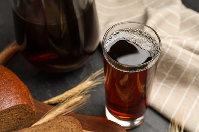 Photo of Glass of delicious kvass on table, closeup