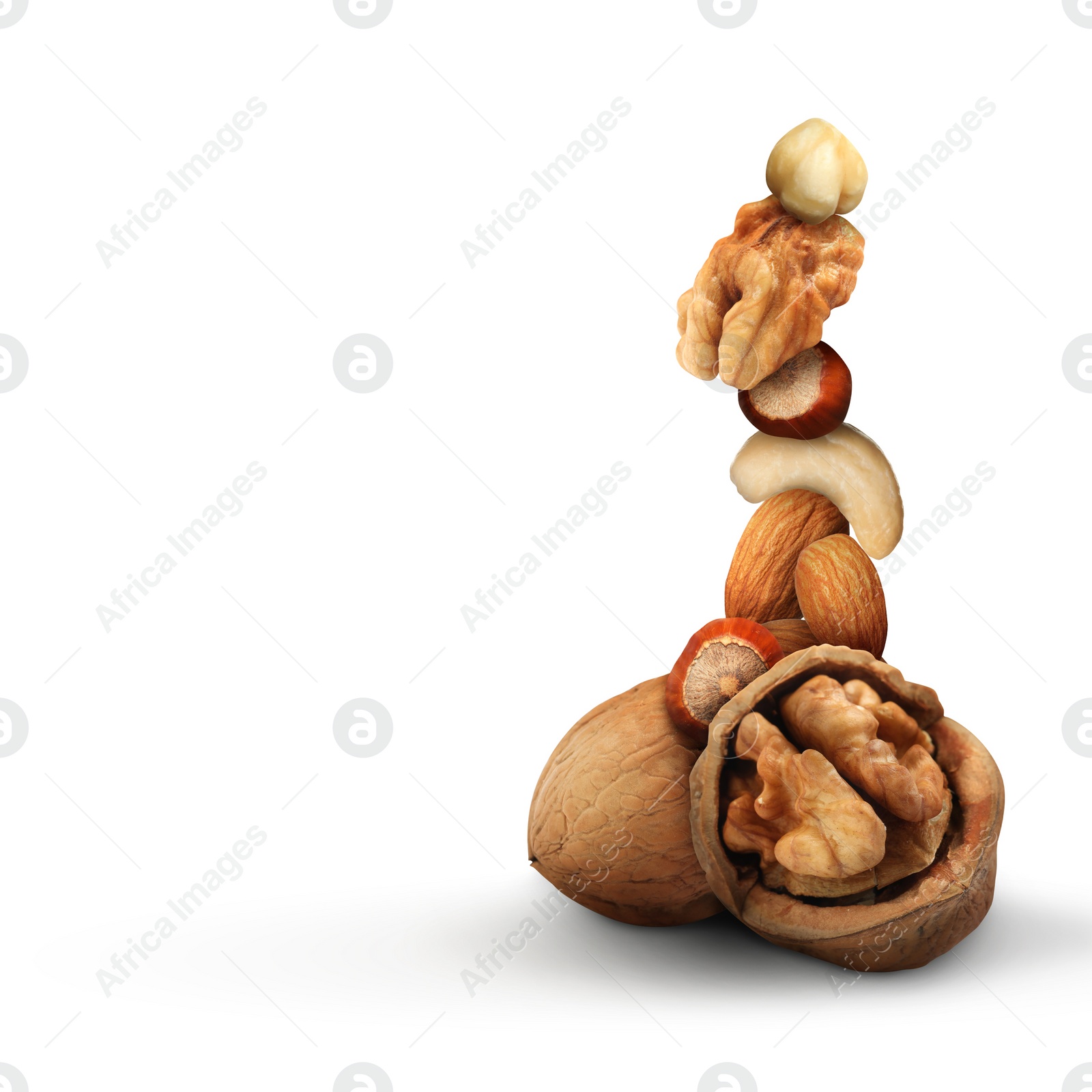 Image of Stack of different nuts on white background