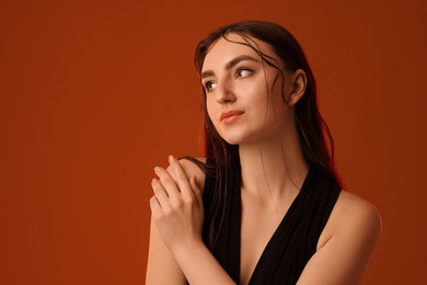 Portrait of beautiful woman on brown background