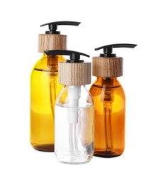Photo of Bottles with dispenser caps on white background