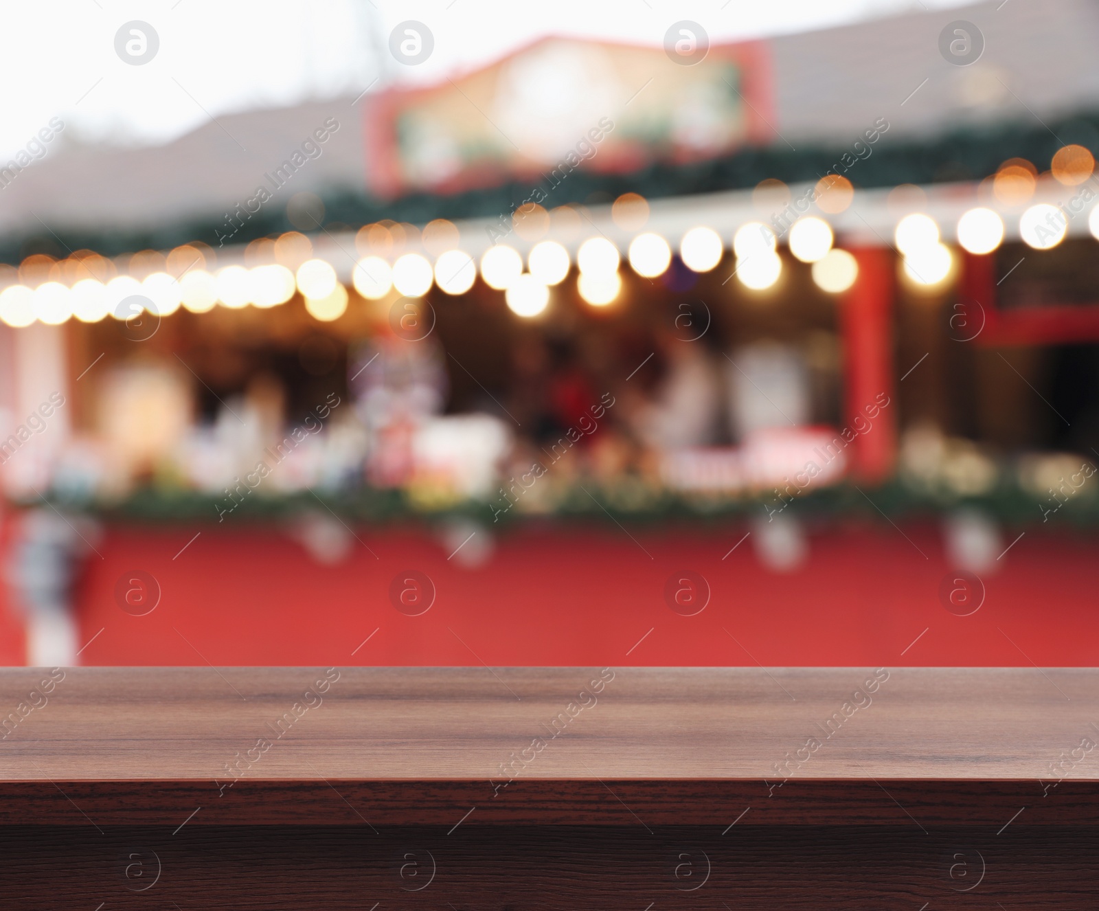 Image of Empty wooden surface and blurred view of Christmas fair stall outdoors. Space for design