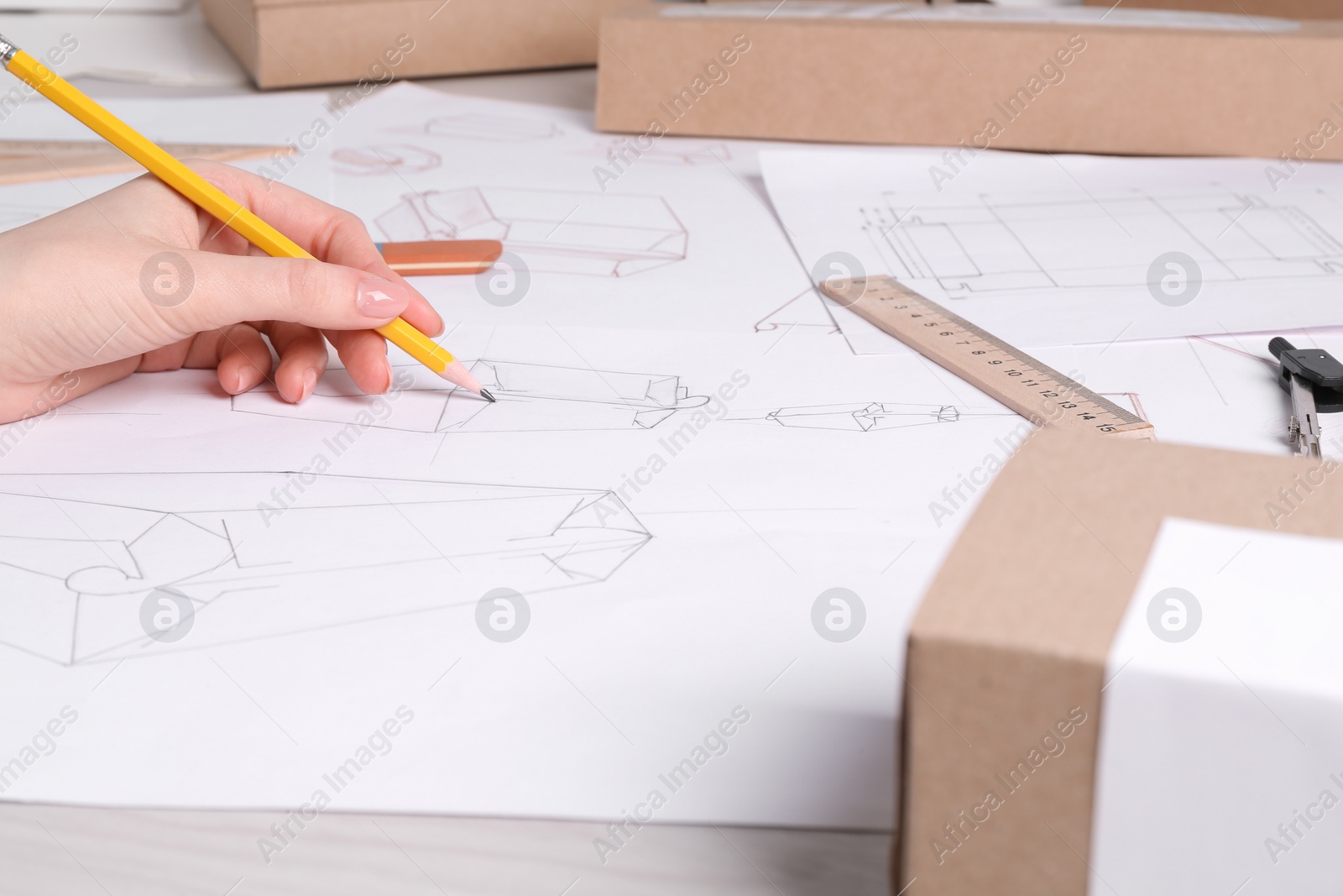 Photo of Woman creating packaging design at table, closeup