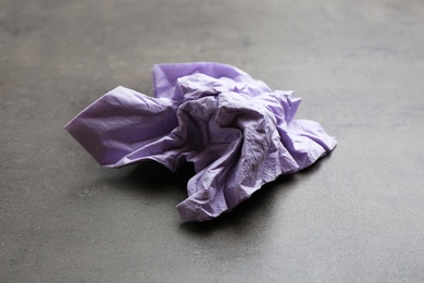 Photo of Crumpled paper napkin on grey background. Personal hygiene