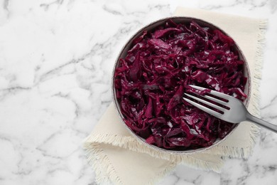 Photo of Tasty red cabbage sauerkraut on white marble table, top view. Space for text