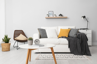 Photo of Elegant white sofa in modern living room interior