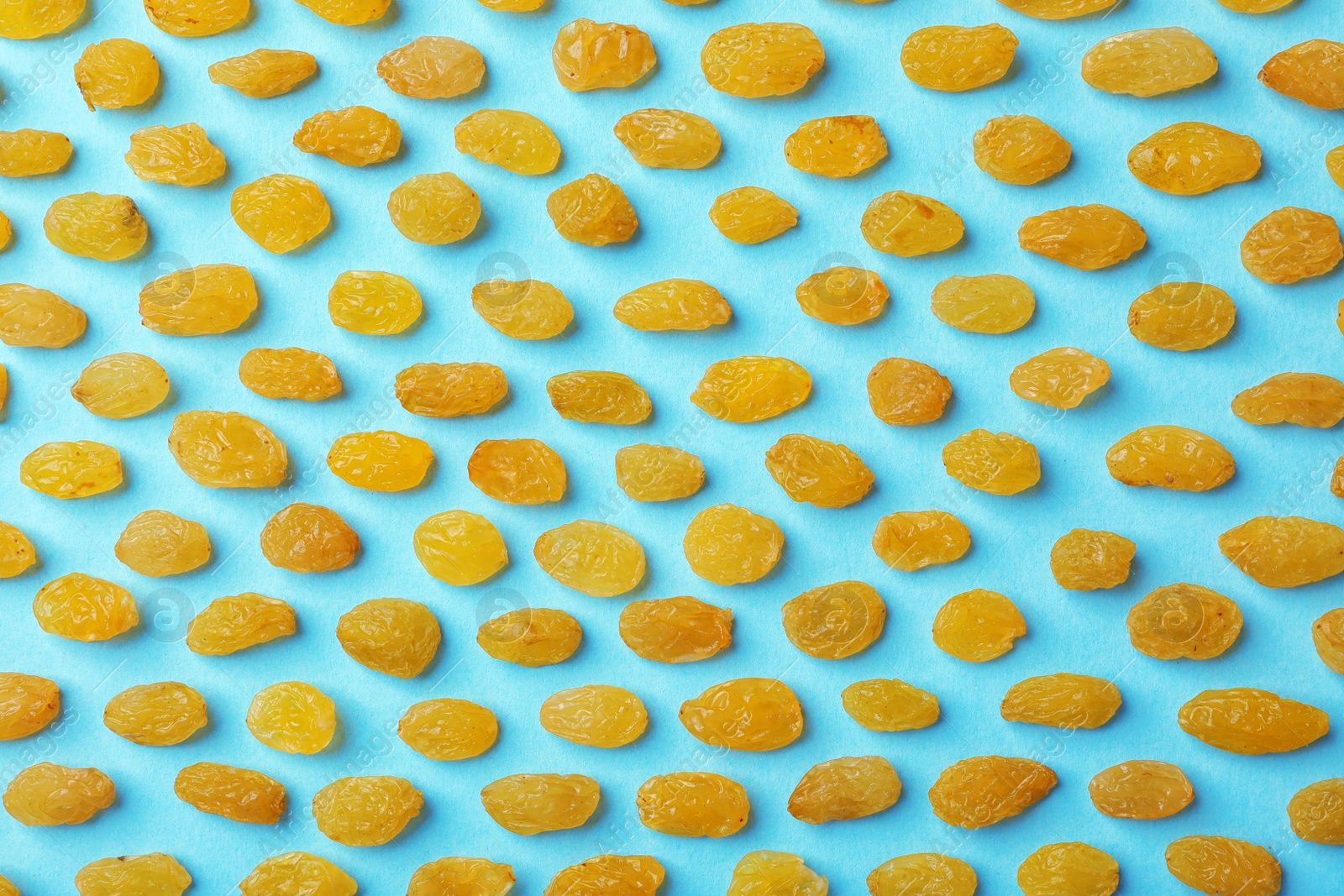 Photo of Flat lay composition with raisins on color background. Dried fruit as healthy snack