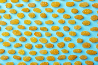 Photo of Flat lay composition with raisins on color background. Dried fruit as healthy snack