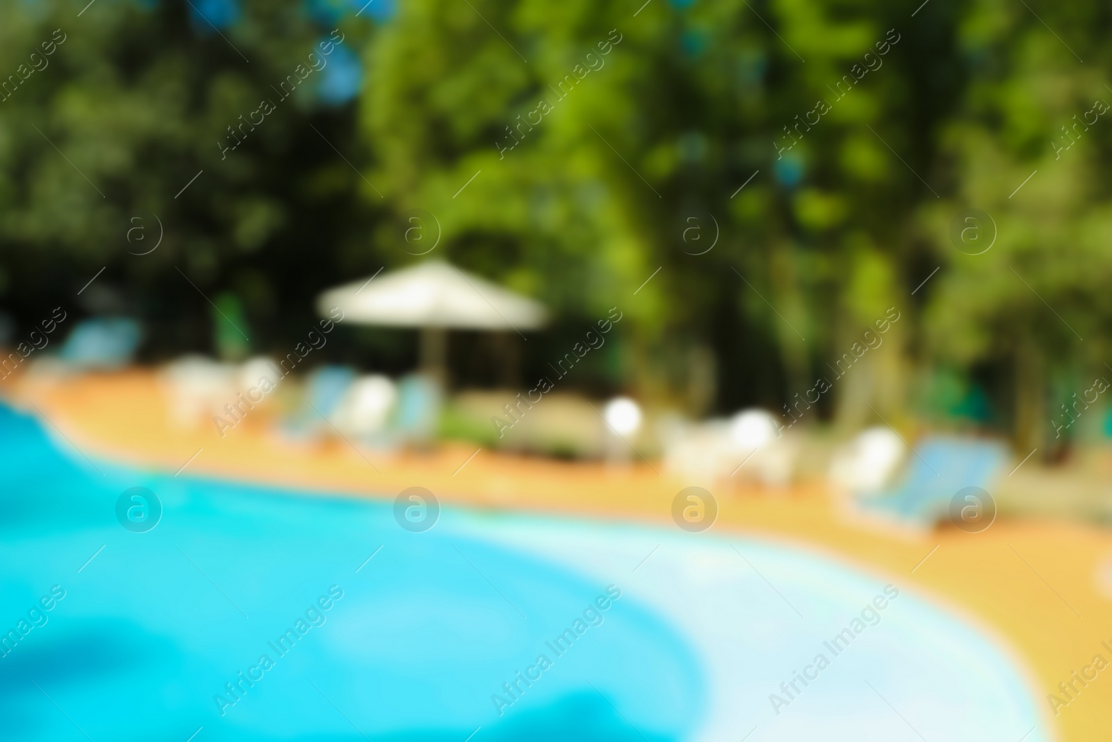 Photo of Blurred view of luxury pool and trees outdoors