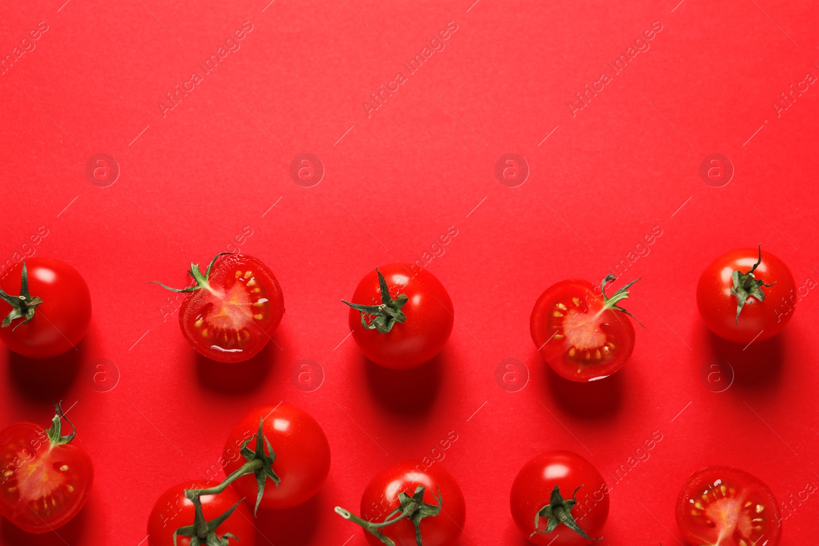 Photo of Flat lay composition with ripe cherry tomatoes on color background. Space for text