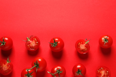 Photo of Flat lay composition with ripe cherry tomatoes on color background. Space for text