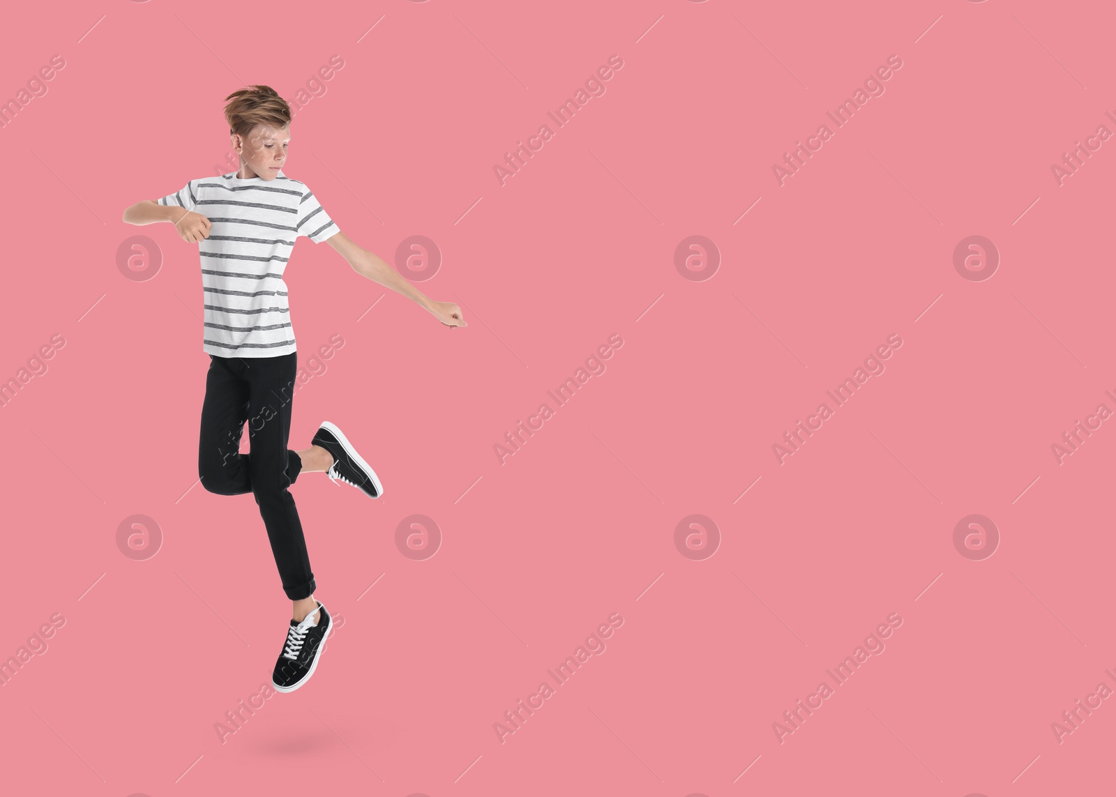 Image of Boy jumping on pink background, space for text