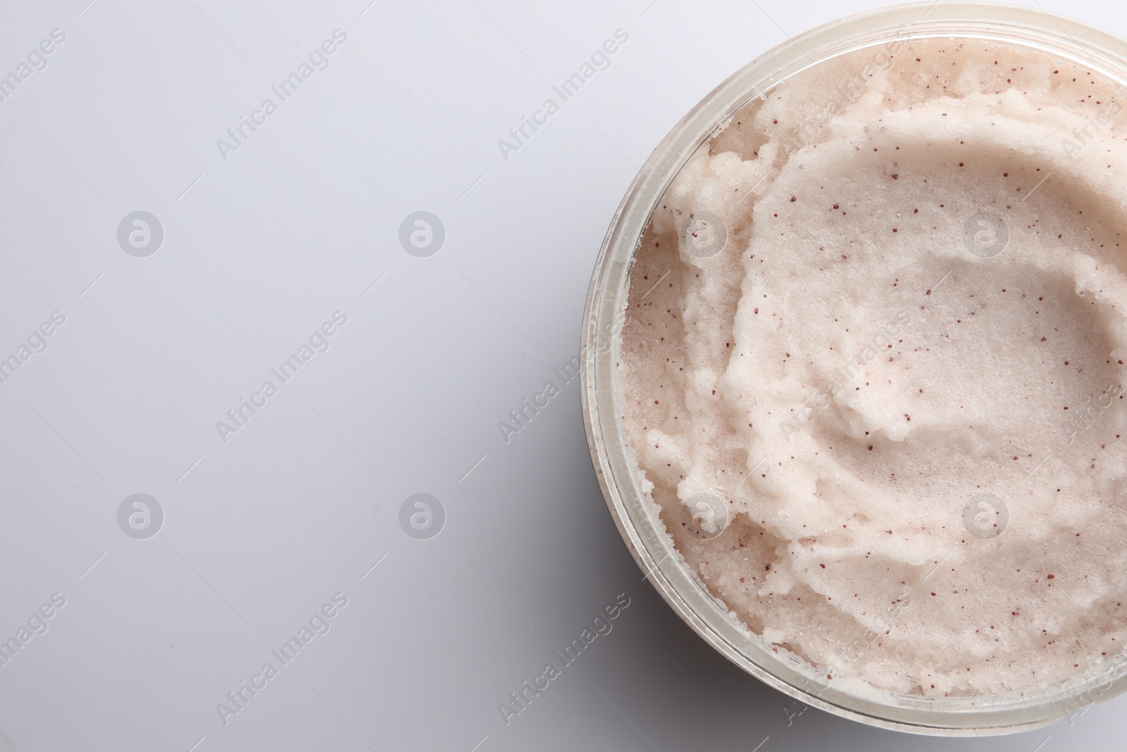 Photo of Jar of scrub on white background, top view