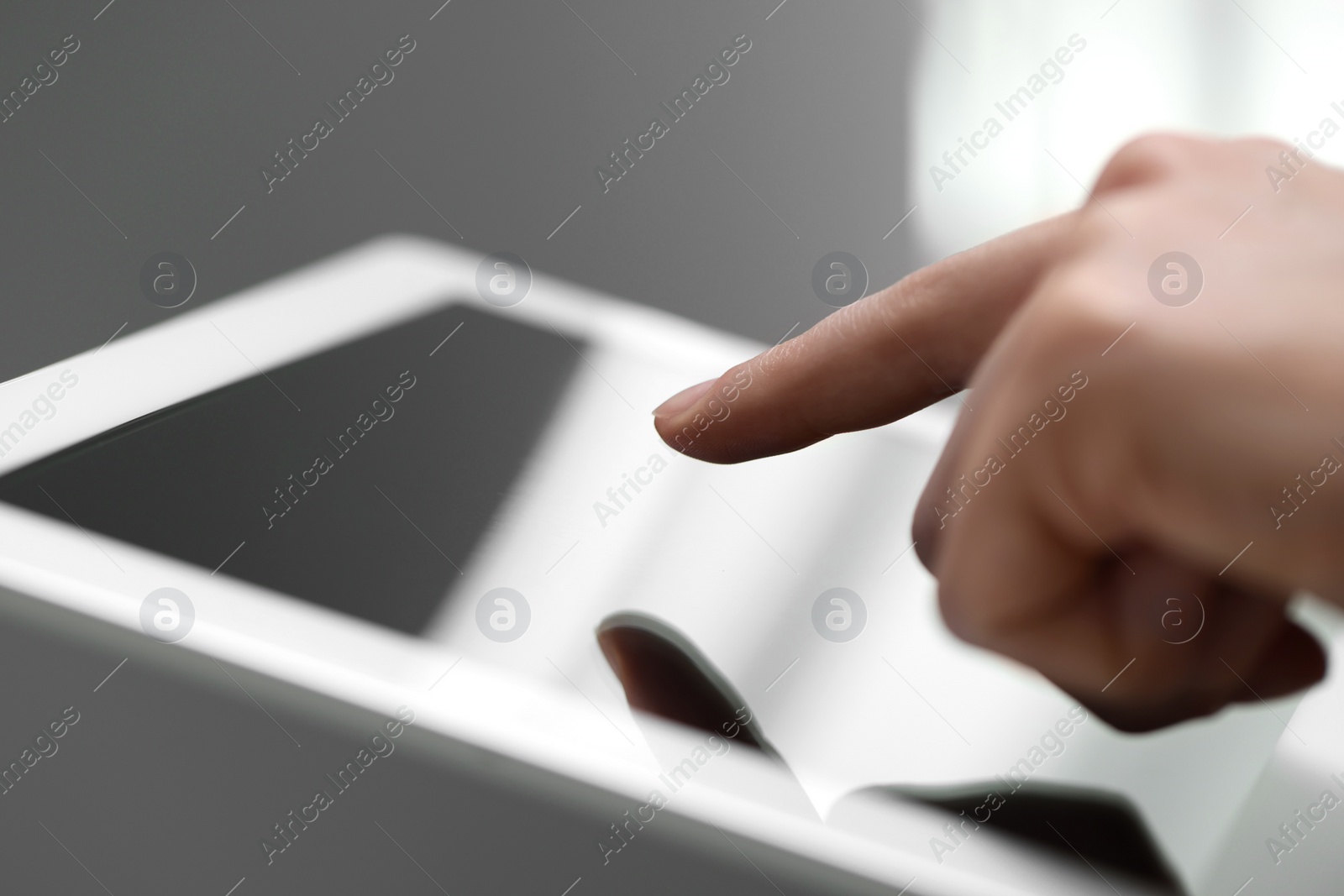 Photo of Closeup view of woman using modern tablet on blurred background