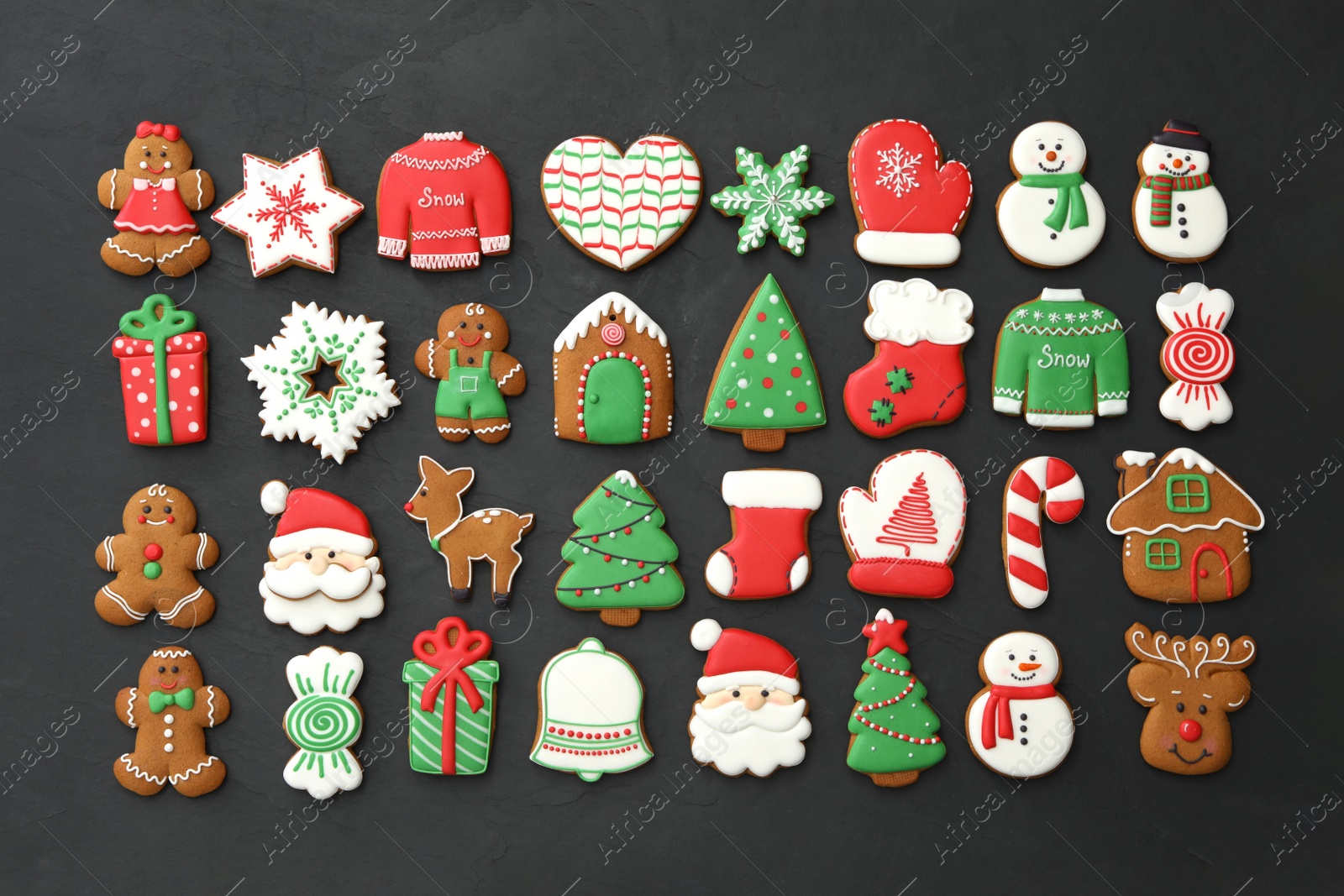 Photo of Many different delicious Christmas cookies on black table, flat lay