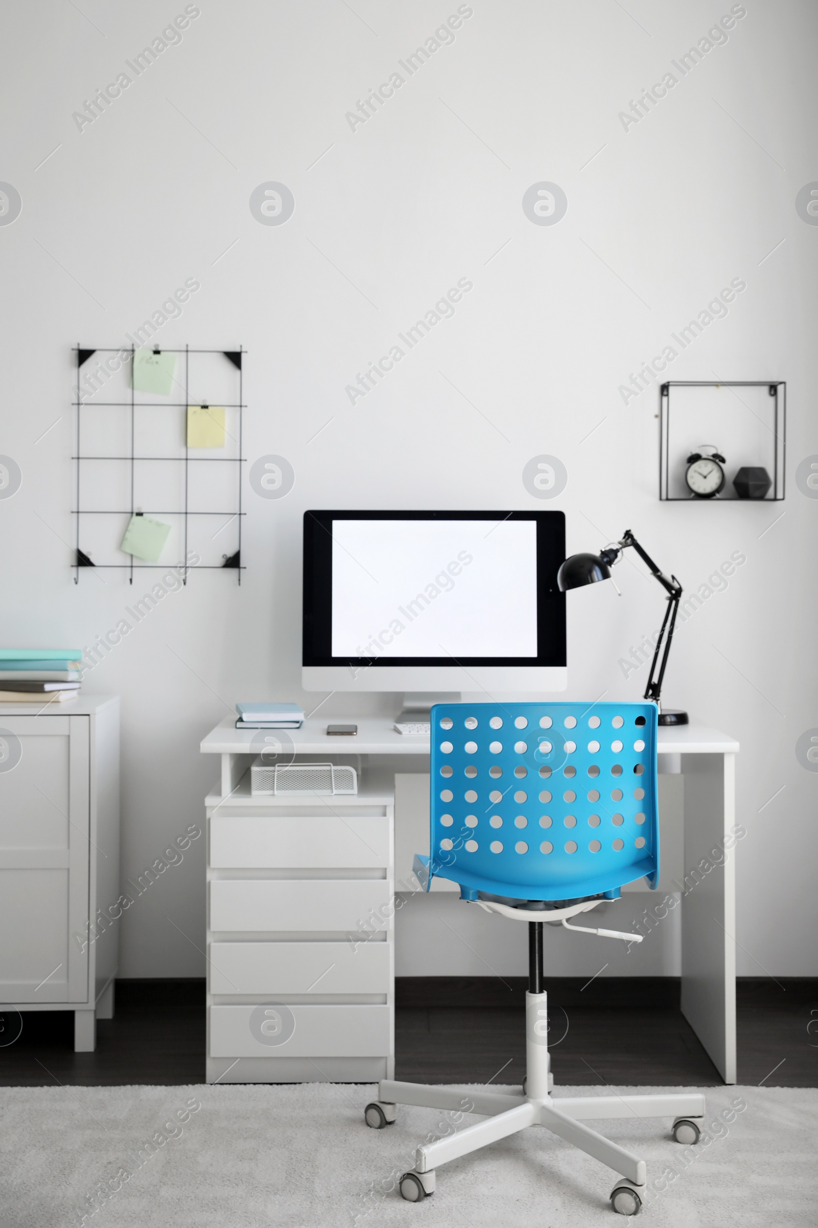 Photo of Comfortable blue chair near desk in stylish office interior