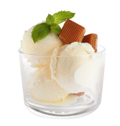 Photo of Glass of delicious ice cream with caramel candies and mint on white background