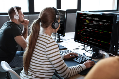Image of Professional programmers working with computers in office