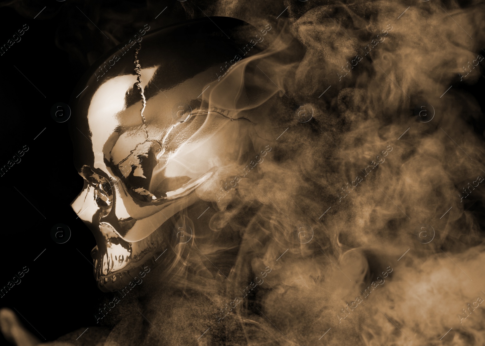 Image of Scary skull emerging from smoke in darkness