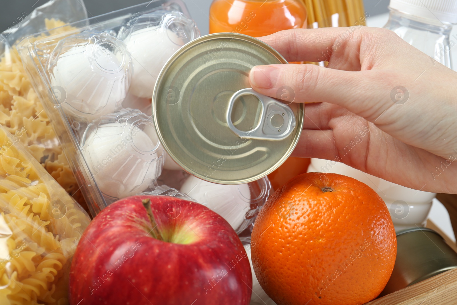 Photo of Humanitarian aid. Woman with food products for donation, closeup