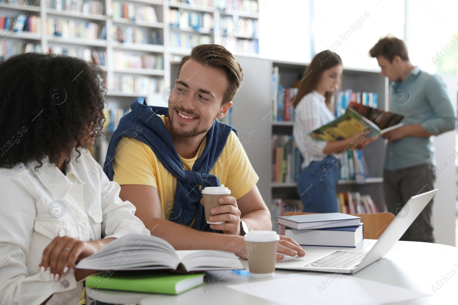 Photo of Group of young people studying in library