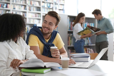 Photo of Group of young people studying in library