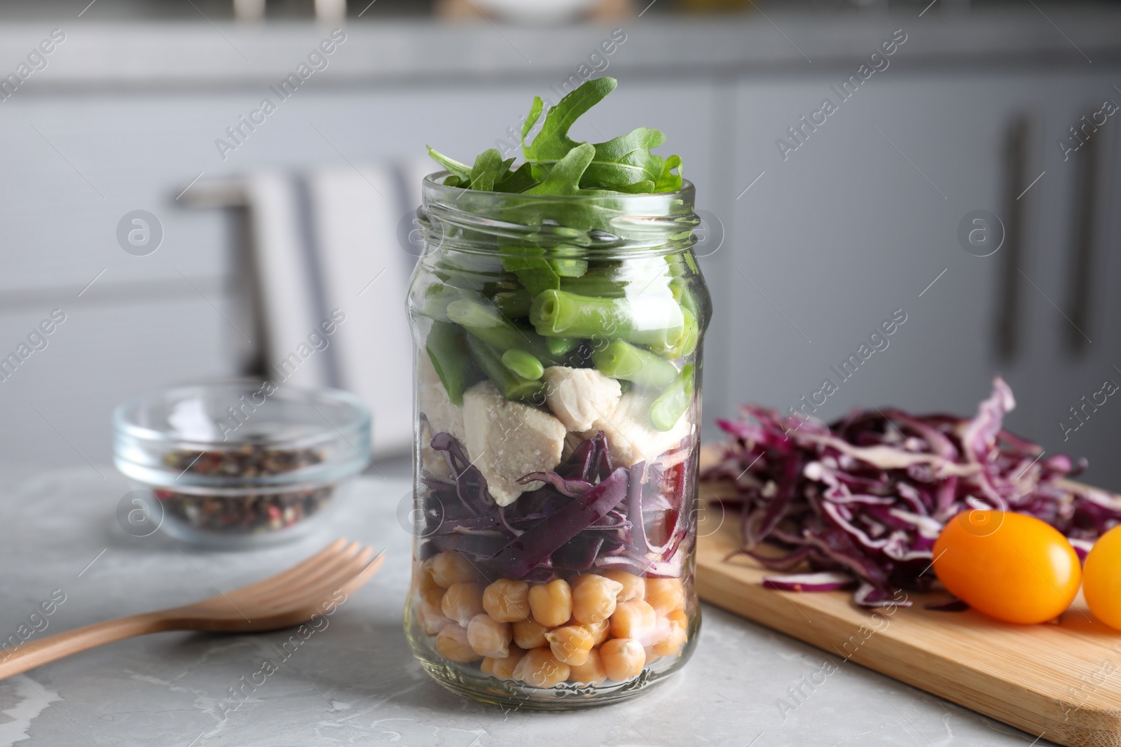 Photo of Glass jar with healthy meal on light grey marble table