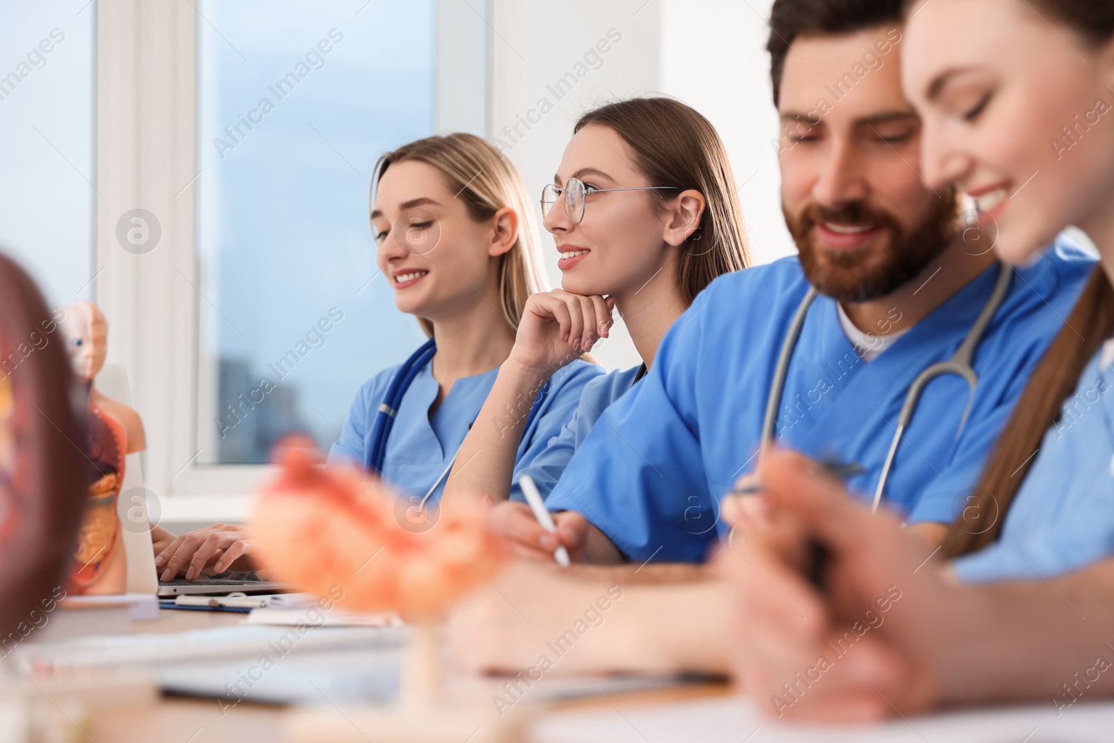 Photo of Medical students in uniforms studying at university